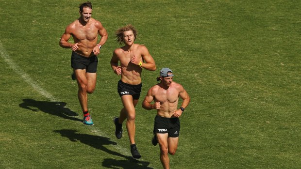 Running back: Travis Colyer leads fellow banned Bombers Dyson Heppell (centre) and Jobe Watson during a training session.