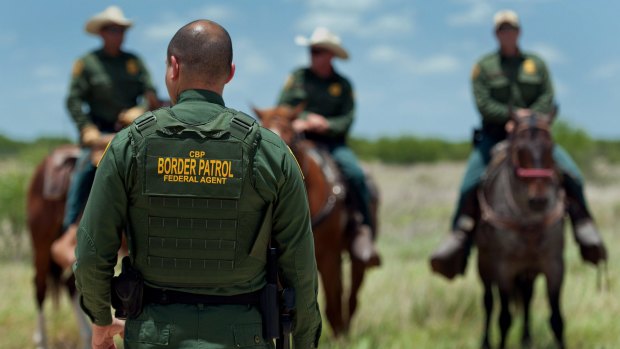 US Border Patrol agents work in a field near Carrizzo Springs, Texas, last year. 