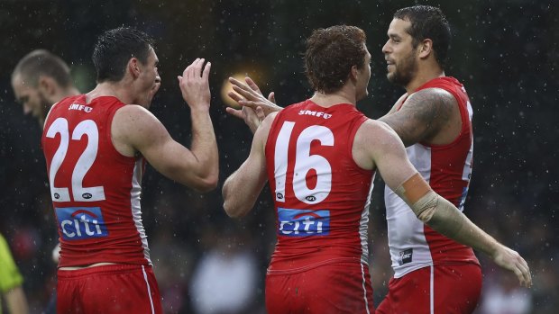 On target: Lance Franklin revelled in the wet, booting four goals.