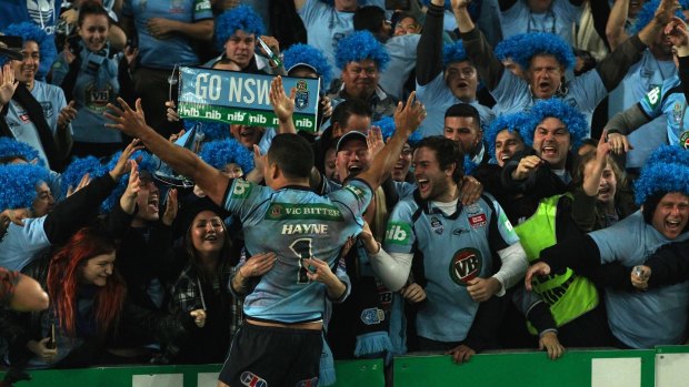 Jubilation: Hayne celebrates with NSW fans after the final whistle in game two brought to an end Queensland's run of eight series wins.