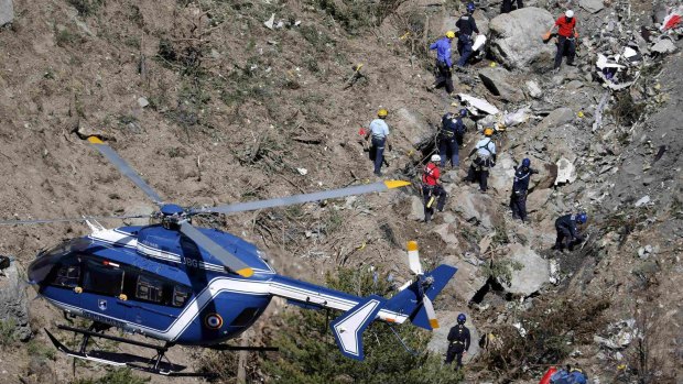 French investigators work through the debris of the crash in the French Alps.