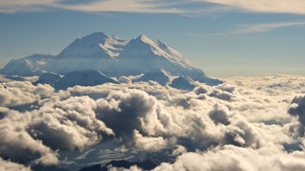 Mount McKinley, now known as Denali, pierces the clouds above Denali National Park and Preserve in Alaska.