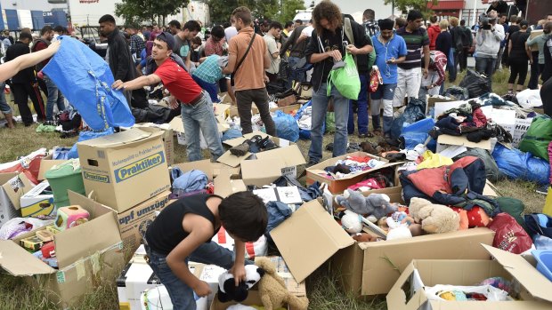 Boxes of donated clothes and children's toys at a refugee shelter in Heidenau, Germany.