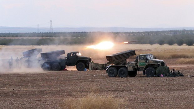 Syrian army rocket launchers fire near the village of Morek in Syria on Wednesday. 