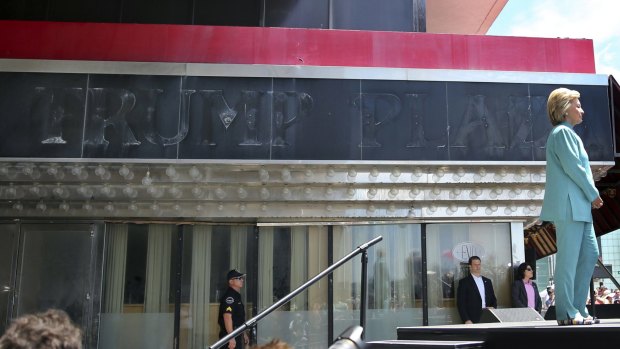 Hillary Clinton stands near the faded sign of the Trump Plaza, which closed permanently on September 16, 2014, as she waits to address a gathering in Atlantic City, New Jersey, last month.