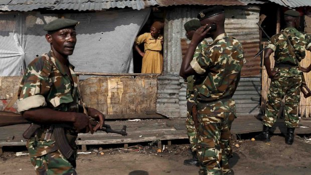 Soldiers stand guard during a protest against Burundi President Pierre Nkurunziza in Bujumbura on Tuesday.