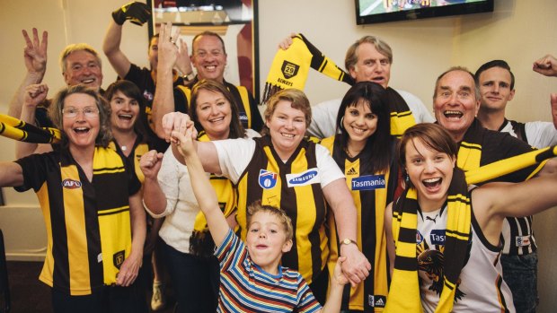 Hawks fans celebrate the AFL premiership win on Saturday afternoon at the Southern Cross Club in Phillip.

