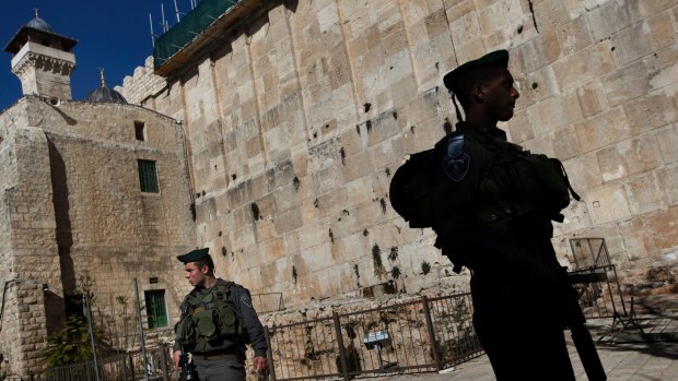 Israeli border police stand guard on the site known to Jews as the Cave of the Patriarchs, and to Muslims as the Ibrahimi Mosque, in Hebron. 
