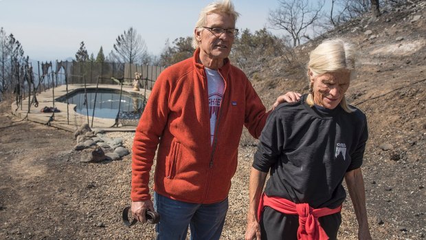 John and Jan Pascoe survived the firestorm on Monday morning by running out of their home and into their neighbour's pool.