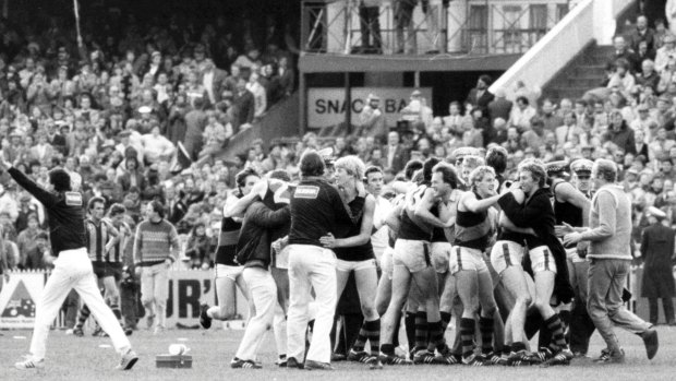 Jubilant Essendon players and officials celebrate their 1984 grand final win.