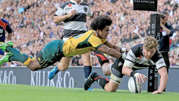 Handy pick-up: Reds recruit Adam Thomson scores a try for the Barbarians against the Wallabies in November.