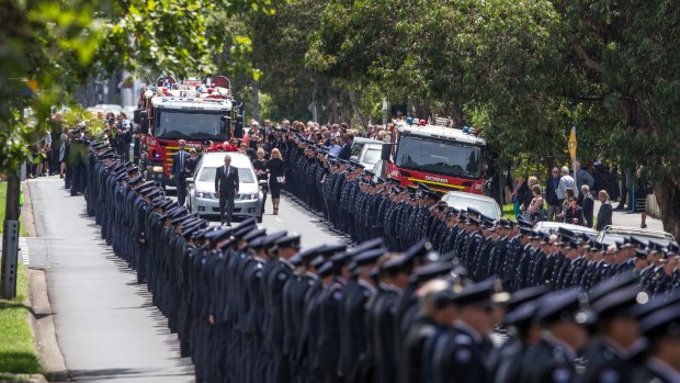 Hundreds of fireman form a guard of honour for the funeral of Damien Burke.