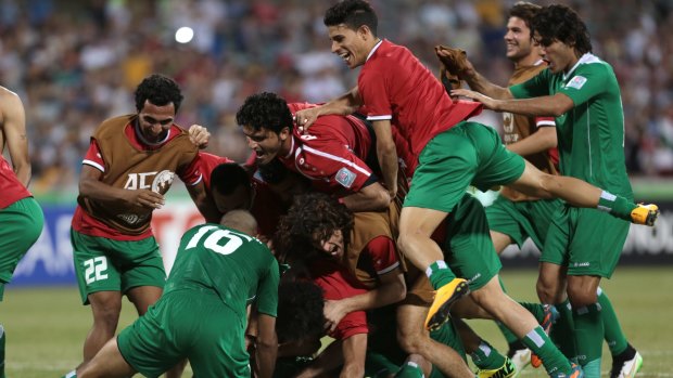 What drama: Iraqi players celebrate their penalty shootout victory over Iran.