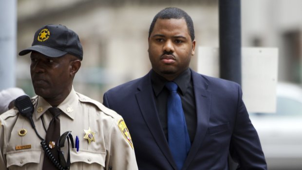 Officer William Porter, right, one of six Baltimore city police officers charged in connection to the death of Freddie Gray, arrives at court last year. 