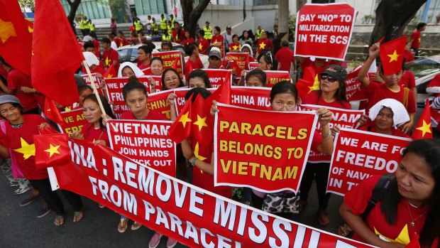 Filipinos and Vietnamese expatriates display placards during a rally at the Chinese Consulate to protest China's South China Sea activities. 