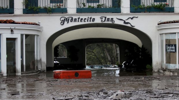Debris and mud cover the entrance of the Montecito Inn after heavy rain brought flash flooding and mudslides to the area on Tuesday.