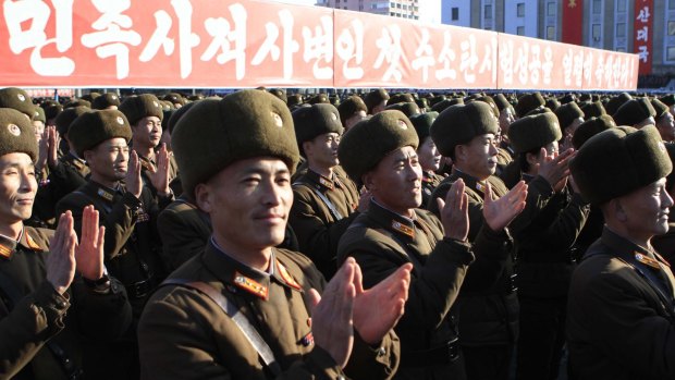 North Korean military personnel clap after North Korea said it had conducted a hydrogen bomb test. 