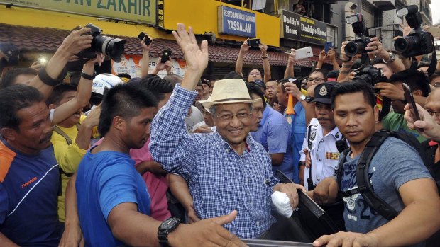 Malaysia's former Prime Minister Mahathir Mohamad waves to activists at a protest  rally in Kuala Lumpur last month. 