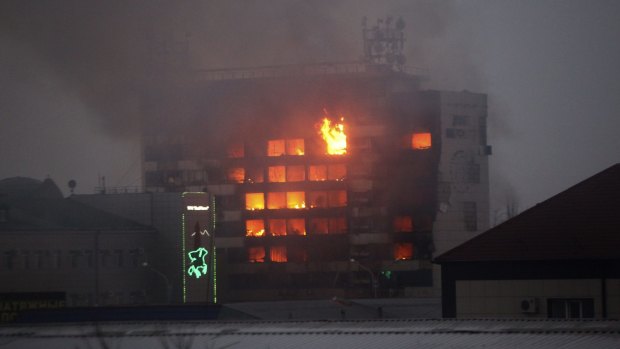 Violent conflict: A publishing house building is seen in flames in the centre of Grozny during the battle.