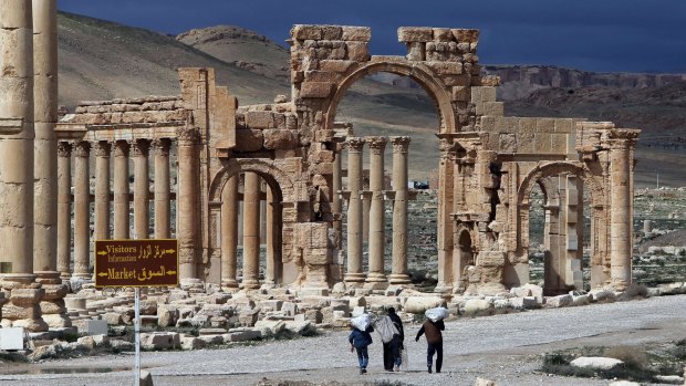 Living in fear ... Syrian citizens walk in the ancient city of Palmyra, 215 kilometres northeast of Damascus. The historical city fell to Islamic State militants on Thursday.