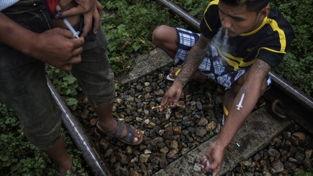 Drug addicts inject heroin in the Kachin State of Myanmar last year.The drug and jade trades in Myanmar have become a toxic mix, enriching the military elite, rebel leaders and Chinese financiers.