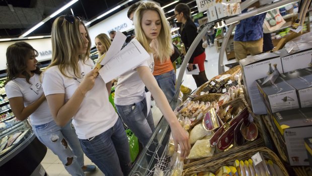 Members of "Eat the Russian food" movement check food at a Moscow food store this week.