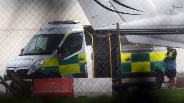 A man believed to be Shaker Aamer is treated in an ambulance after arriving at Biggin Hill Airport on Friday.