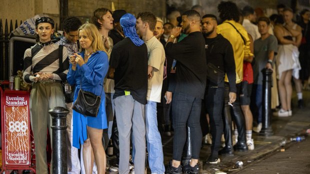 Londoners queue for entry at a nightclub on Saturday after England lifted its remaining COVID-19 restrictions