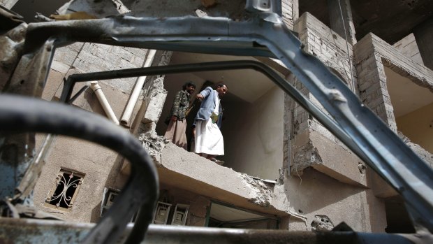Yemenis inspect a house damaged by a Saudi air strike in the rebel-held capital Sanaa.