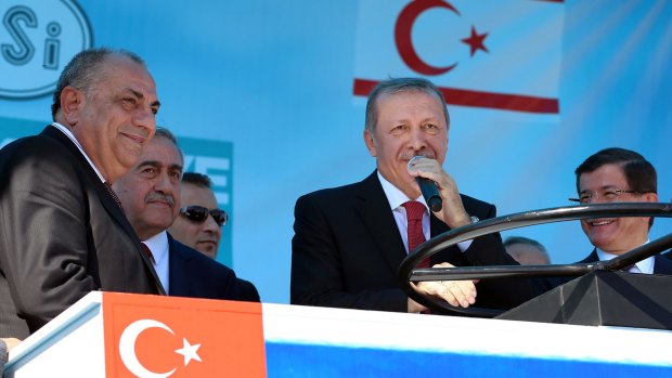 Turkish President Recep Tayyip Erdogan, centre, speaks at the water pipeline ceremony flanked by Turkish Cypriot leader Mustafa Akinci, second left, and Turkish Prime Minister Ahmet Davutoglu, right.