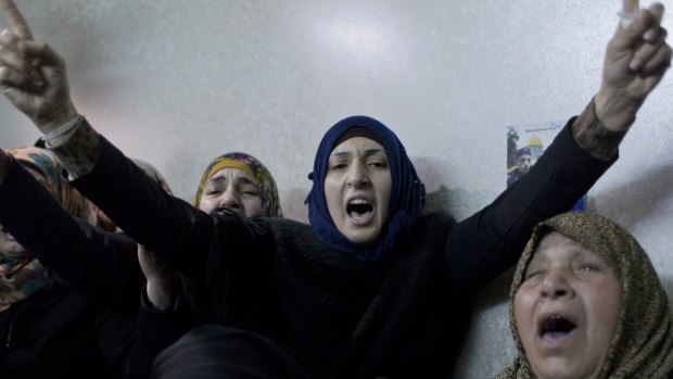 Palestinian women view the body of Ramzi al-Qasrawi, 21, during his funeral in the West Bank city of Hebron in March, 2016.