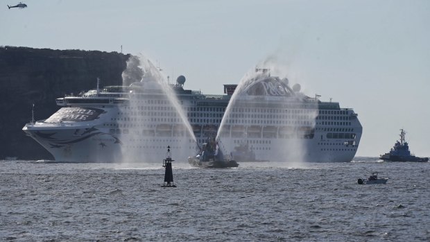 Tugs fired water cannons in celebration as they escorted Pacific Explorer into Sydney Harbour.