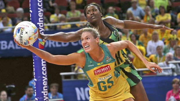 Contest: Australia's Caitlin Bassett reaches for the ball, battling with Jamaica's Romelda Aiken during their Netball World Cup semi-final.