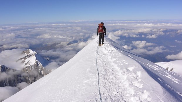 Huw Kingston stands on Mount Blanc Summit, France.