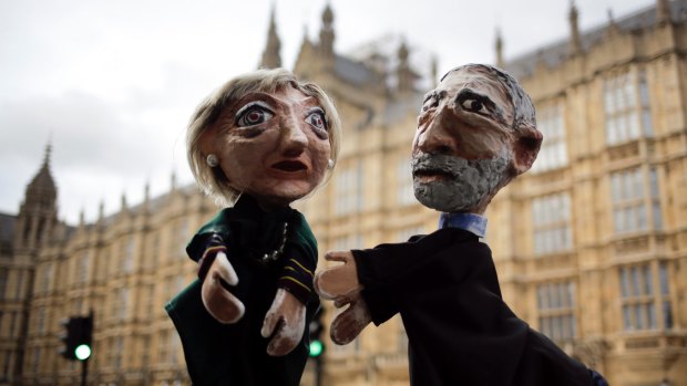 Two anti-Brexit activists pose with their hand-puppets depicting British Prime Minister and leader of the Conservative Party Theresa May and Britain's Labour Party leader Jeremy Corbyn.