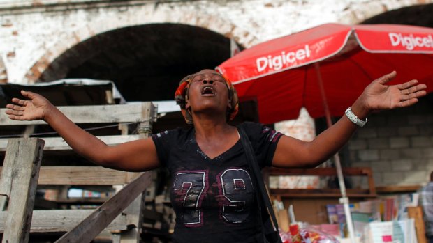 A woman prays on the street in Port-au-Prince, Haiti before the November elections.