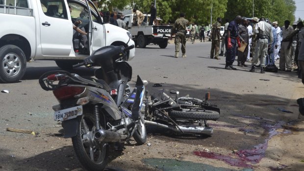 Security officers stand at the site of a suicide bombing in Ndjamena, Chad, on Monday.