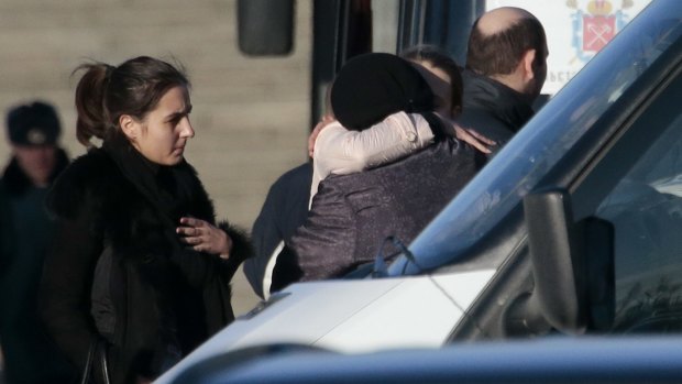 Relatives stand at a facility, where identification of plane crash victims is held in St Petersburg, Russia, on Tuesday.