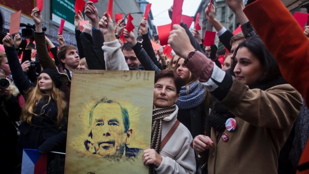 The Czechs have long memories of Russian domination. A woman holds a placard with a picture of former president of Vaclav Havel on the 25th anniversary of the Velvet Revolution. 