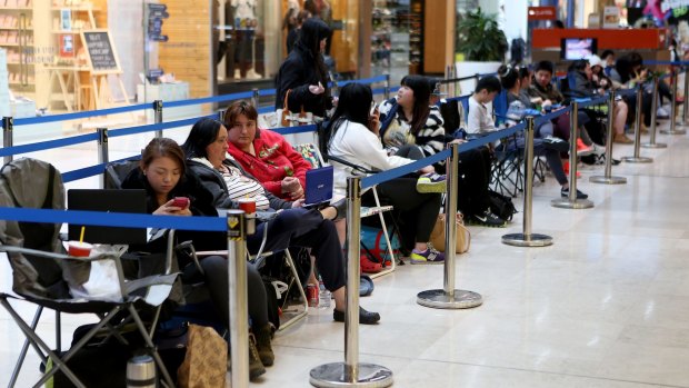 Melbourne customers queue for the new iPhone 6 at the Apple store at Westfield Fountain Gate Shopping Centre on Thursday.