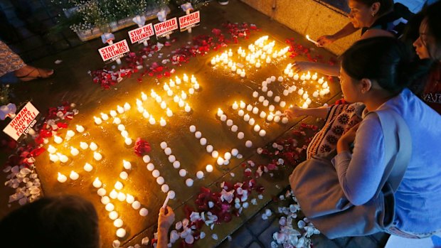 Human rights activists light candles in Quezon City for the victims of extra-judicial killings.