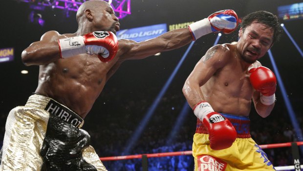 Slippery character: Manny Pacquiao dodges a punch from Floyd Mayweather in their 2015 Las Vegas mega-bout.