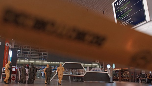 Malaysia's Police Forensic Team, in conjunction with Fire Department and Atomic Energy Licensing Board staff, check Kuala Lumpur International Airport for toxic chemicals.