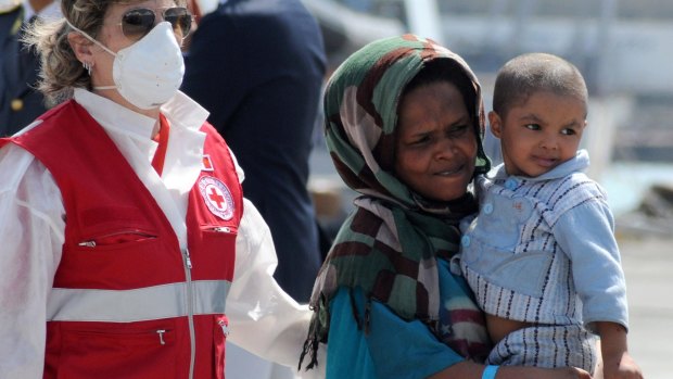 Migrants disembark on Thursday from a Swedish patrol vessel carrying 497 people rescued in three different operations in the Mediterranean.