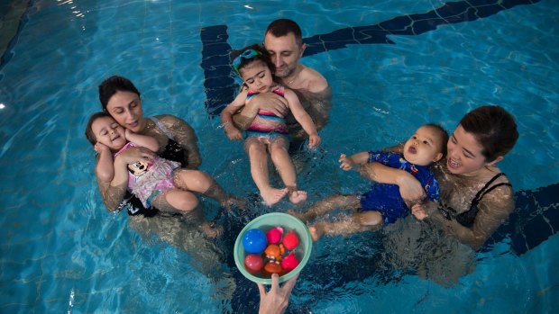 Emilia Garofolo, 2, and mum Amanda; Elsie Kassis with dad Nagib, and Mason, nine months, with mum Jannine Lam were among those at swimming lessons.