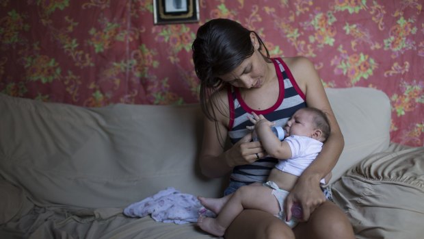 Angelica Pereira feeds her daughter Luiza, who was born with microcephaly, in Santa Cruz do Capibaribe, Brazil.