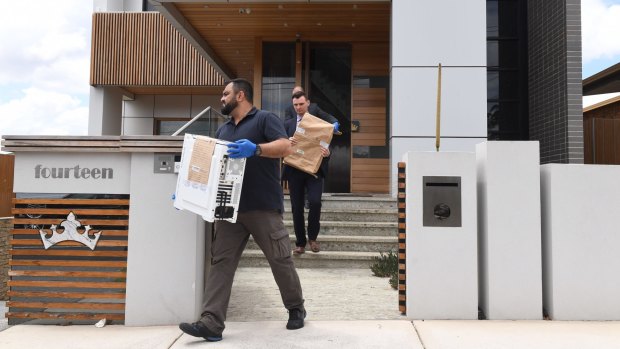 NSW Police remove evidence from the home of former Auburn deputy mayor Salim Mehajer in Sydney.