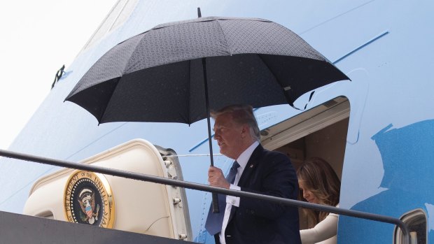 US President Donald Trump and first lady Melania Trump arrive from France as news was breaking about the meeting promising another round of unwelcome headlines.