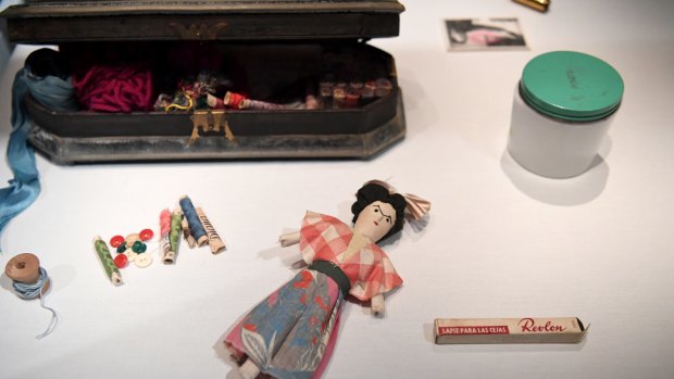 Make-up and personal items including a hand-made doll owned by Mexican artist Frida Kahlo are displayed during a media preview of the exhibition Frida Kahlo: Making Her Self Up at the Victoria and Albert Museum in London.