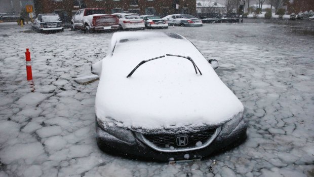 A car sits in frozen floodwaters from Boston Harbour on Long Wharf in Boston.